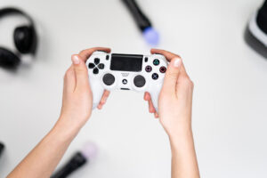 Person Holding Gray and Black Sony Ps 4 Controller